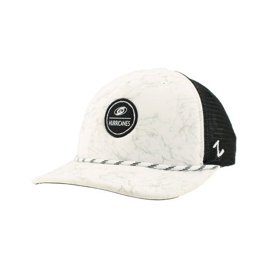 Side: Marble colored hat with white rope on brim, black and white circular graphic on front