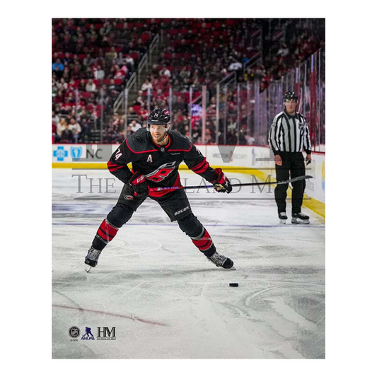 Photo of Jaccob Slavin smiling while winding up for a shot in a game