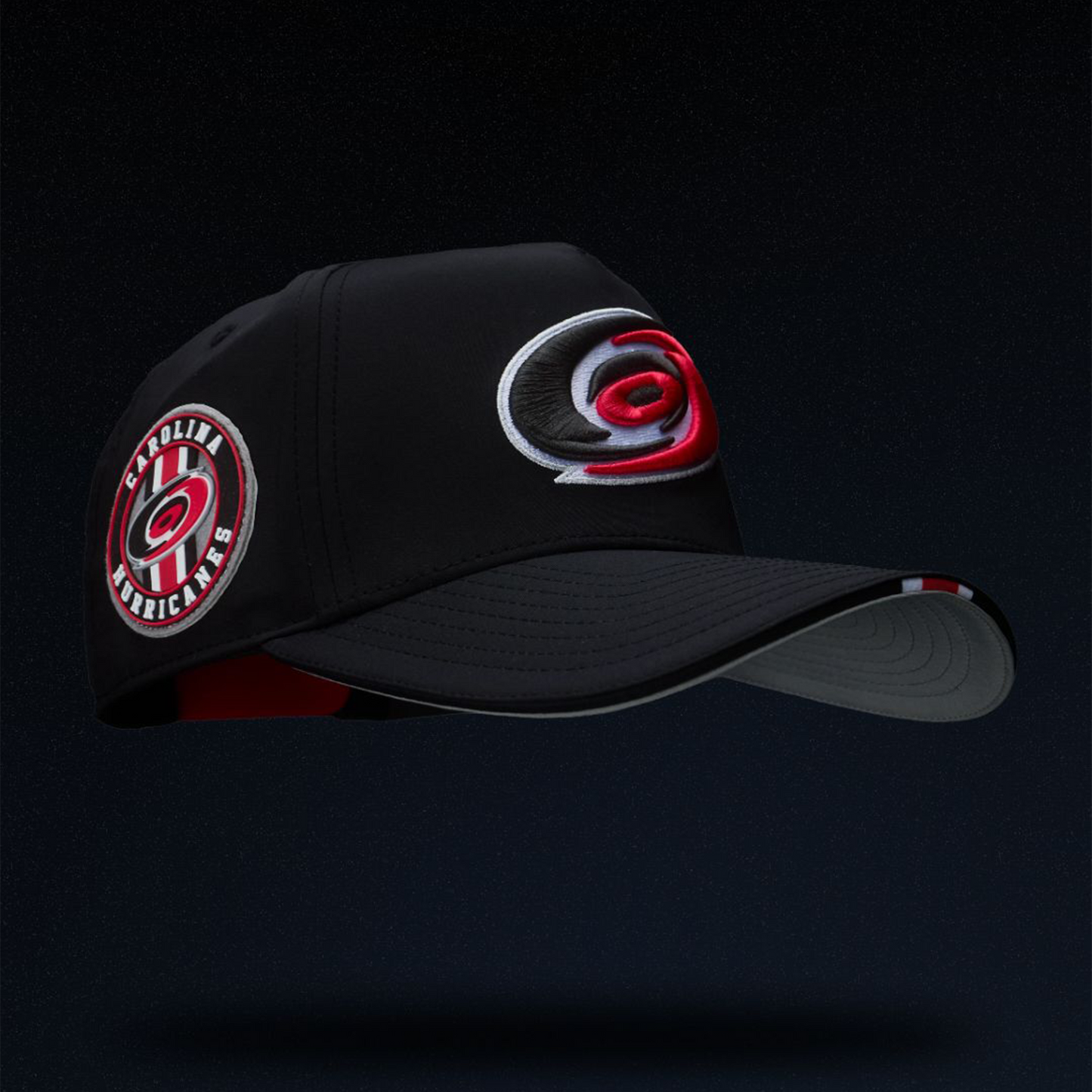 Right: Black hat, primary logo on front, unique Carolina Hurricanes patch on right side