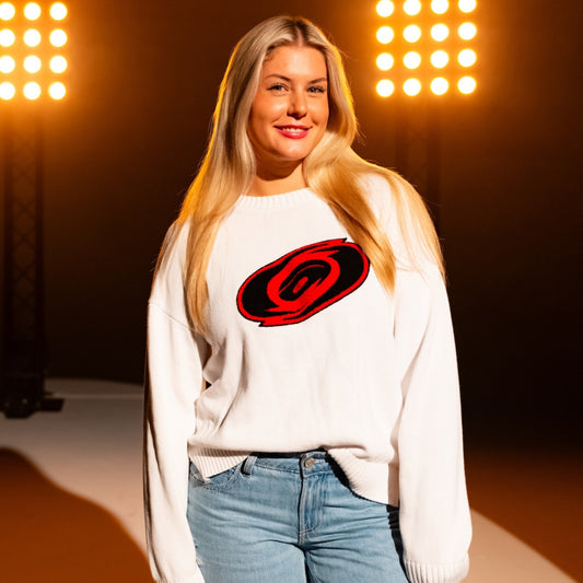 White sweater with Tonal primary logo on front; being worn by model