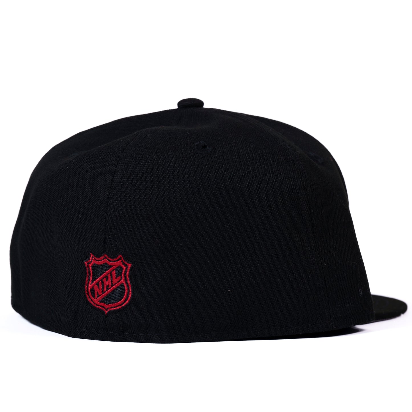 Back: Black fitted hat with red NHL shield on back