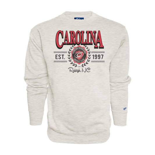 Cream crew, graphic with "CAROLINA", "EST. 1997", "Raleigh, NC" surrounding Hurricanes badge with laurels