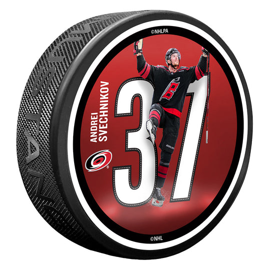 puck with red top face that says Andrei Svechnikov 37 with picture of player