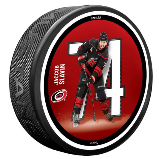 Red puck with picture of Jaccob Slavin in front of his number 74 in white