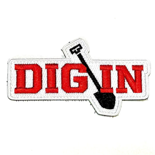 Embroidered patch with velcro back, "DIG IN" in red on white background with black shovel