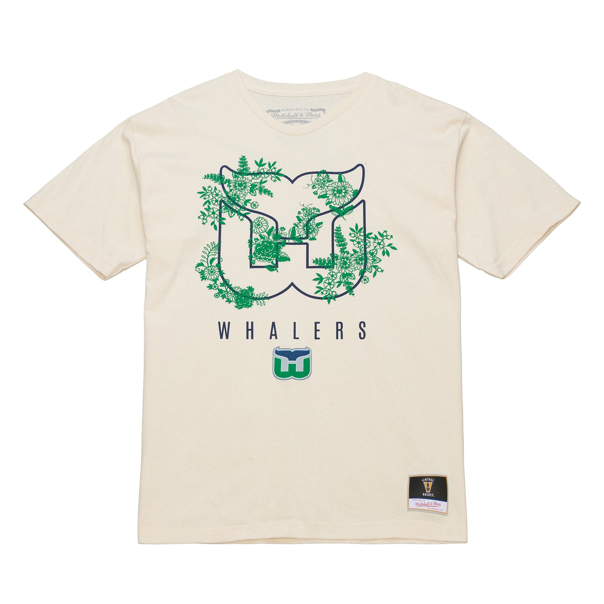 Front: Cream tee, Whalers tail outline logo with foliage, "WHALERS" with Tail logo beneath