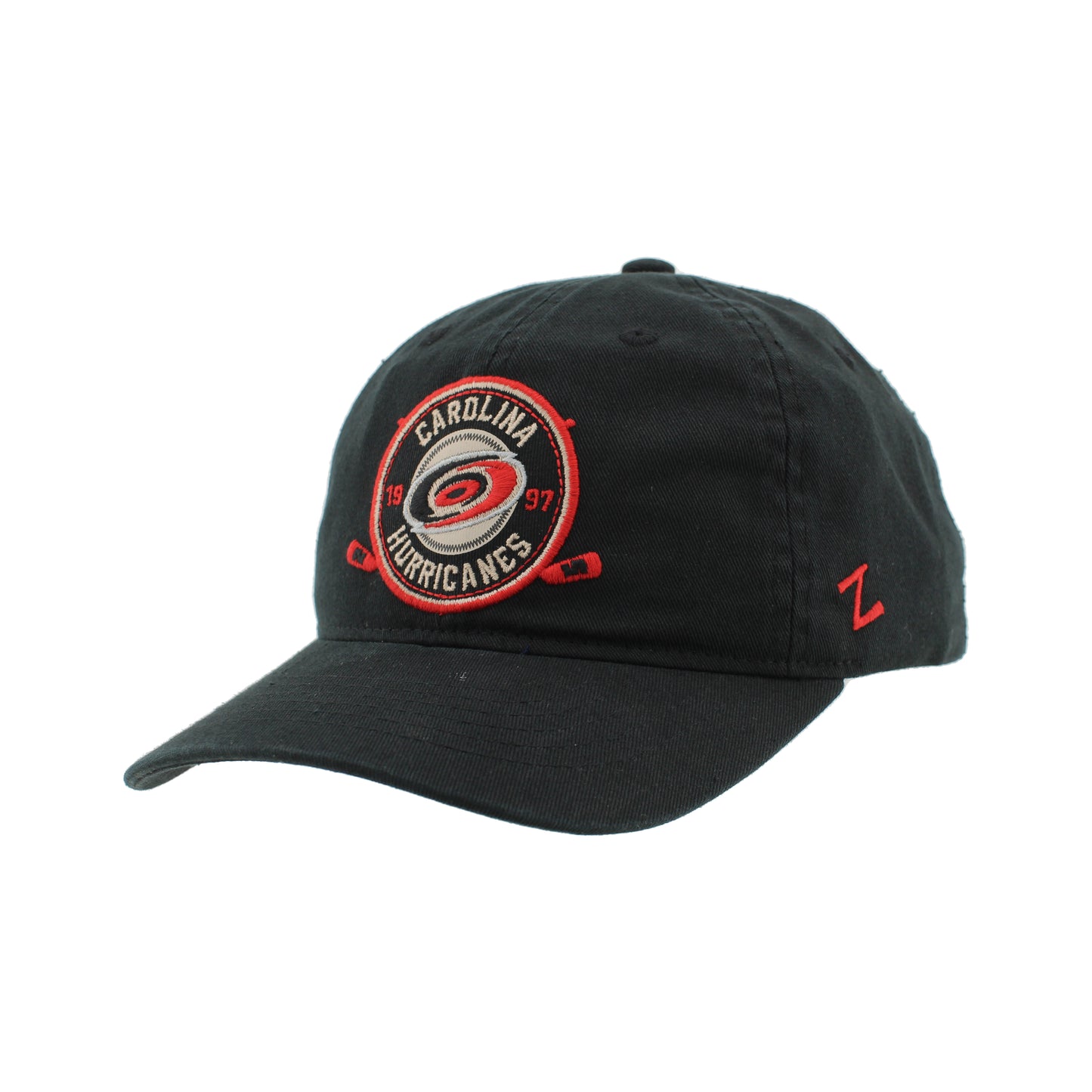 Side: Black hat with circular patch graphic on front, red Zephyr logo on left