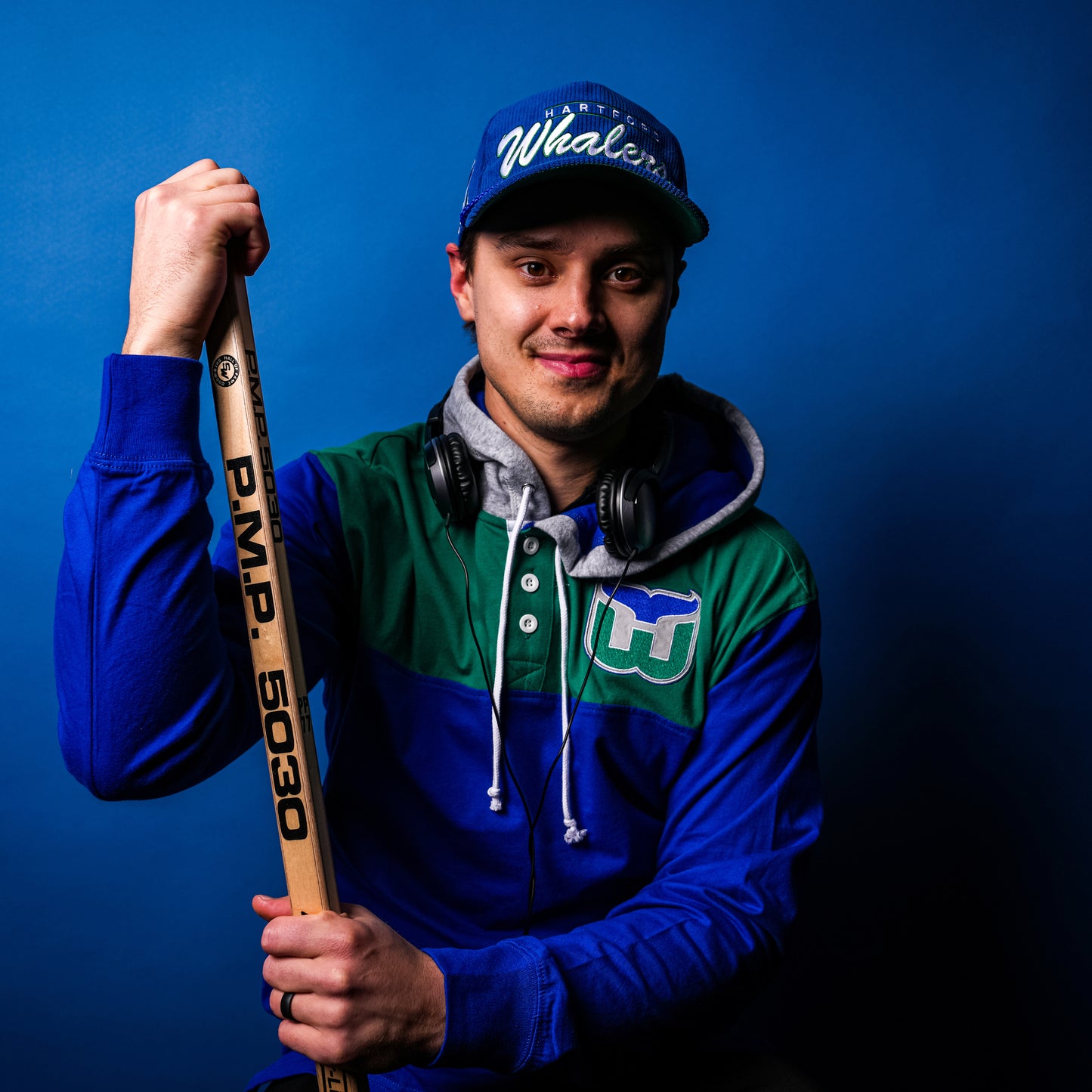 Hurricanes forward Sebastian Aho posing with the hooded polo