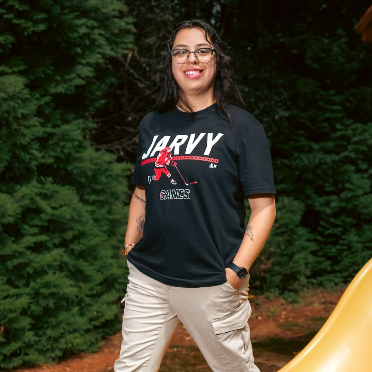 The t-shirt being worn by a model outside in front of trees