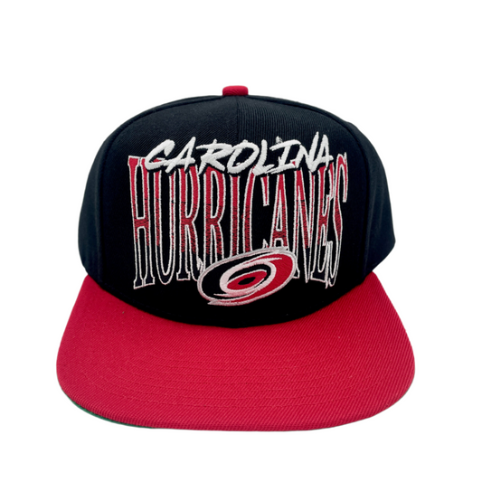 Front: Black hat with red brim, says Carolina in white, Hurricanes in gradient with primary logo