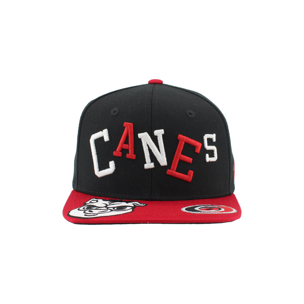 Front: "CANES" in red/white across front, Primary logo & black/white Cartoon Stormy on brim