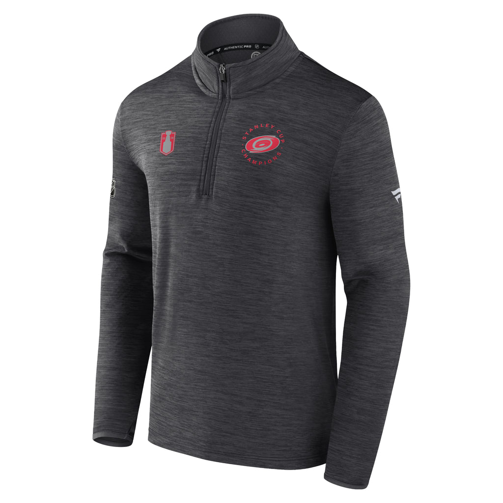 Front: red Stanley Cup art on right chest, "2026 Stanley Cup Champions" with Primary logo in red/silver on left chest