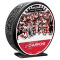 Mega puck, "STANLEY CUP CHAMPIONS" wordmark at bottom below Stanley Cup Team Photo