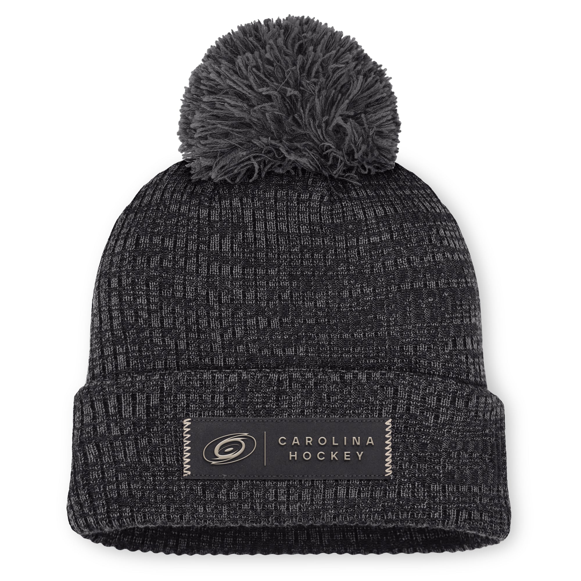 Front: Black cuffed acrylic beanie with grey pom, rectangular "CAROLINA HOCKEY" patch on cuff in black/beige