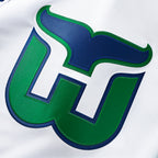 Close up of the blue and green Whalers Tail Logo on front