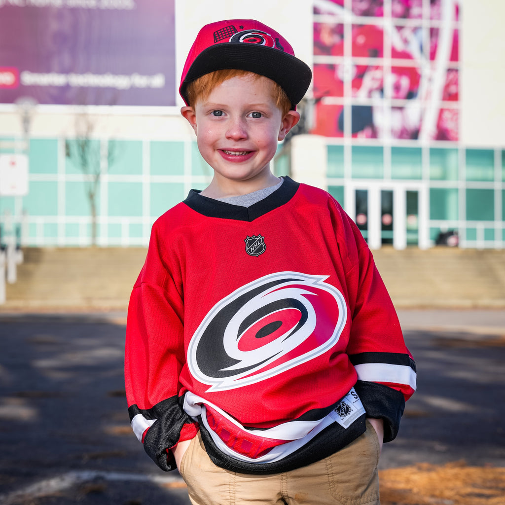 A kid outside the Lenovo Center wearing the jersey