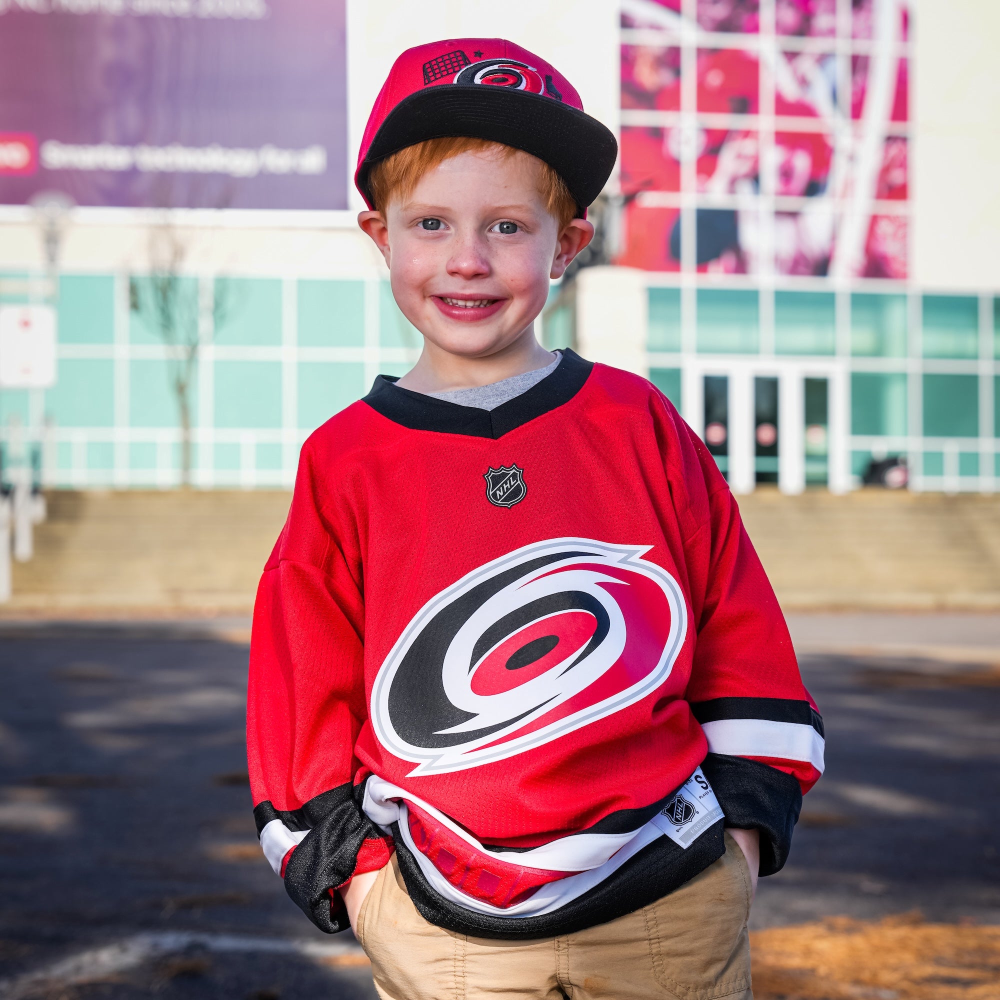 A kid outside the Lenovo Center wearing the jersey