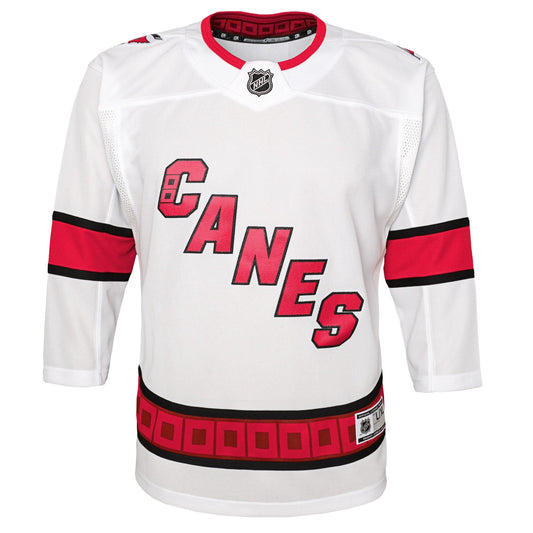 Front: White jersey with black and red striping, Canes diagonally across chest