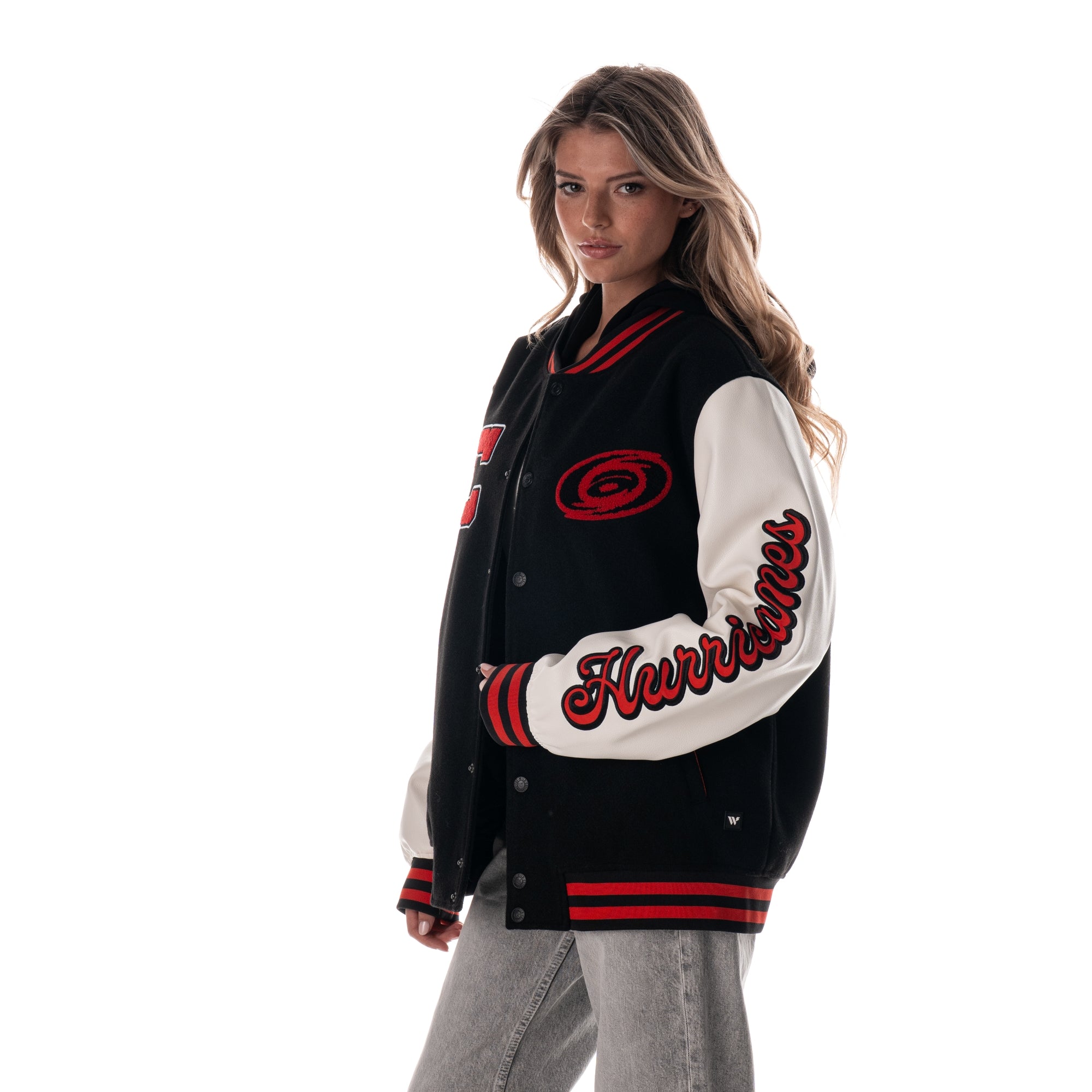 Left: "Hurricanes" in red and black in script down left sleeve