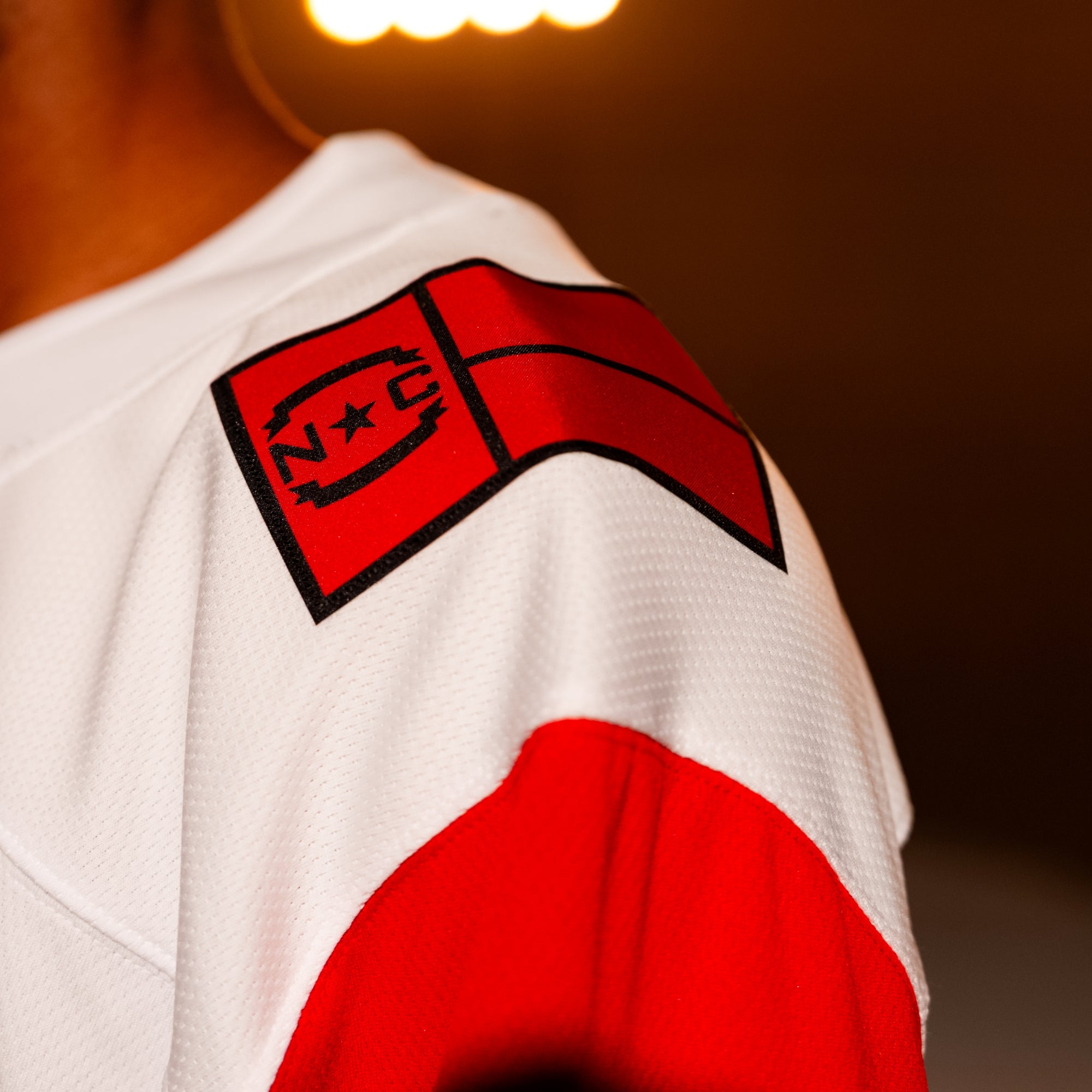 Close up of red NC State Flag patch on left shoulder