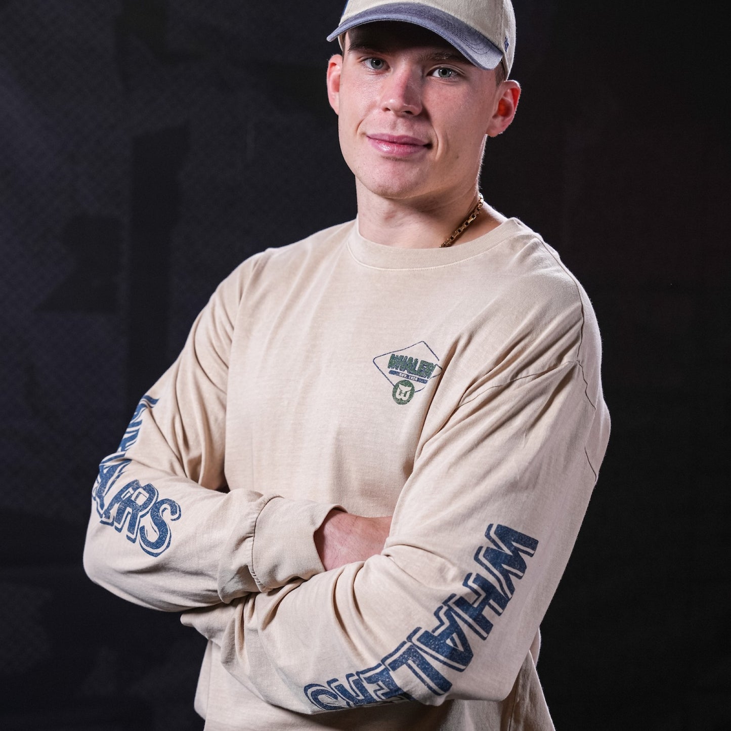 Cream long sleeve tee being worn by Hurricanes defenseman Alexander Nikishin