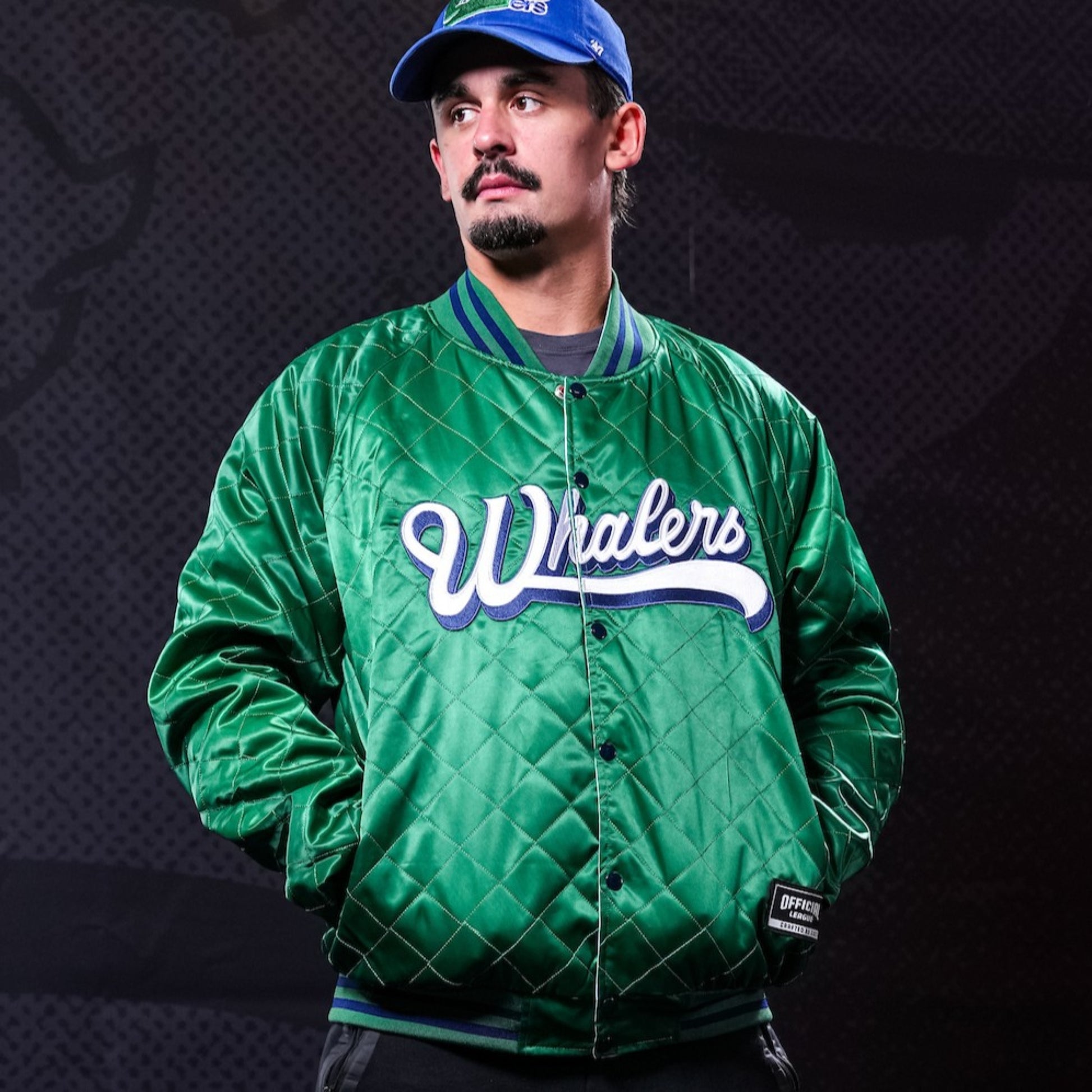 Whalers: Green jacket, "Whalers" script wordmark across front