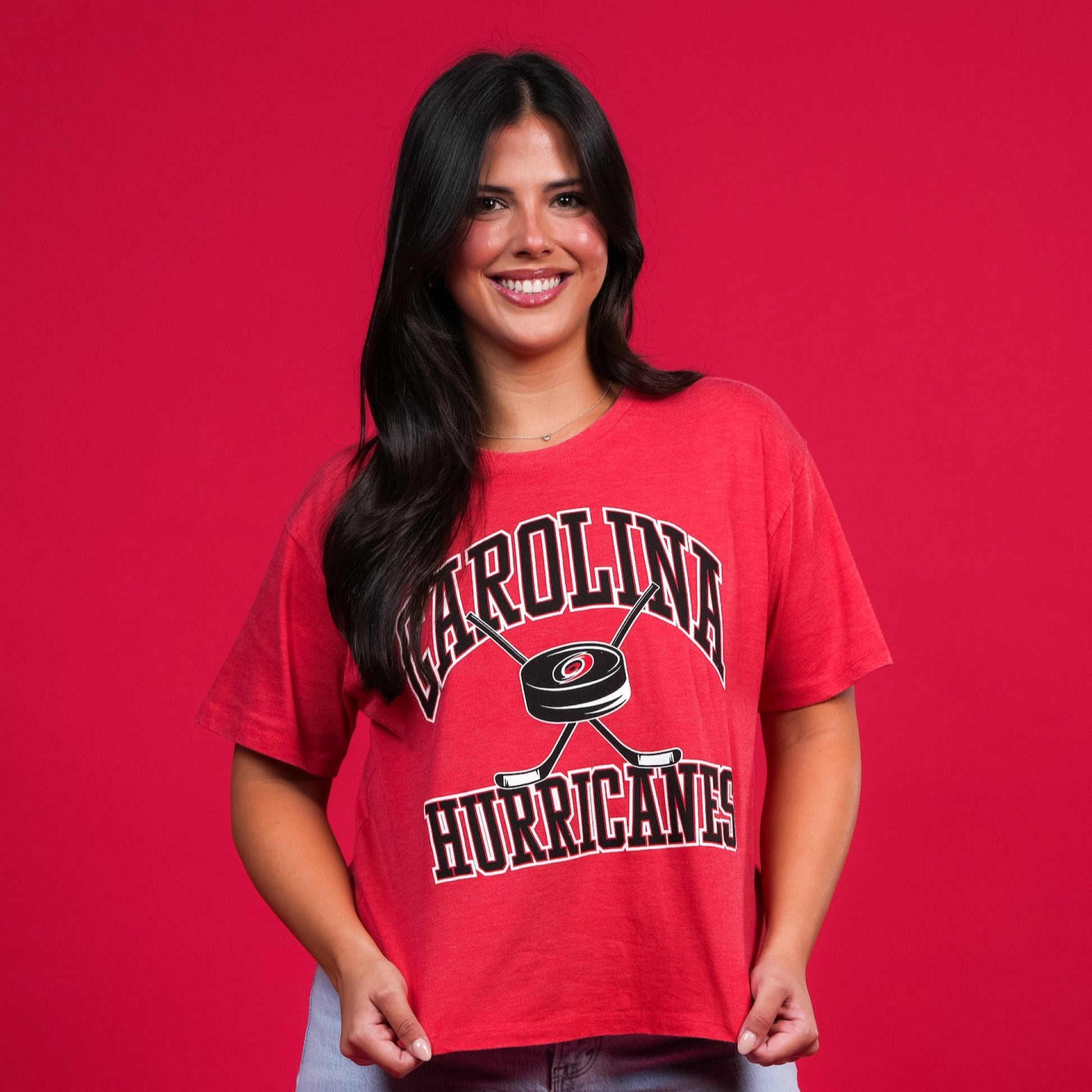 The shirt being worn by a model in front of a red backdrop