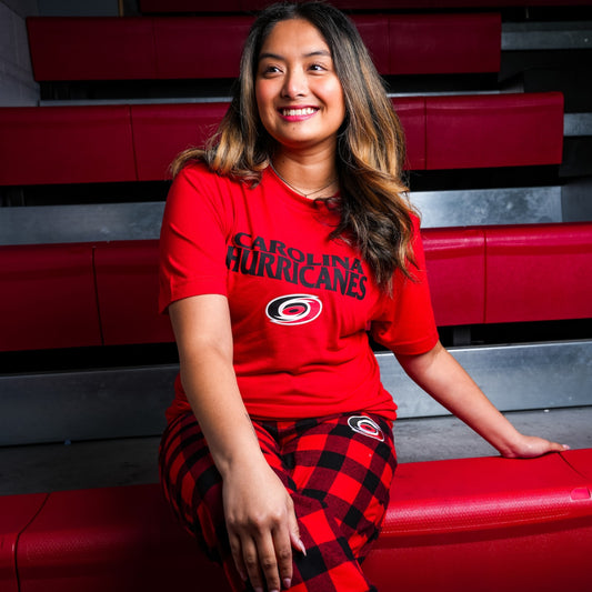 Red tee, "CAROLINA HURRICANES" in black; Red/black flannel pants, Primary logo left pant