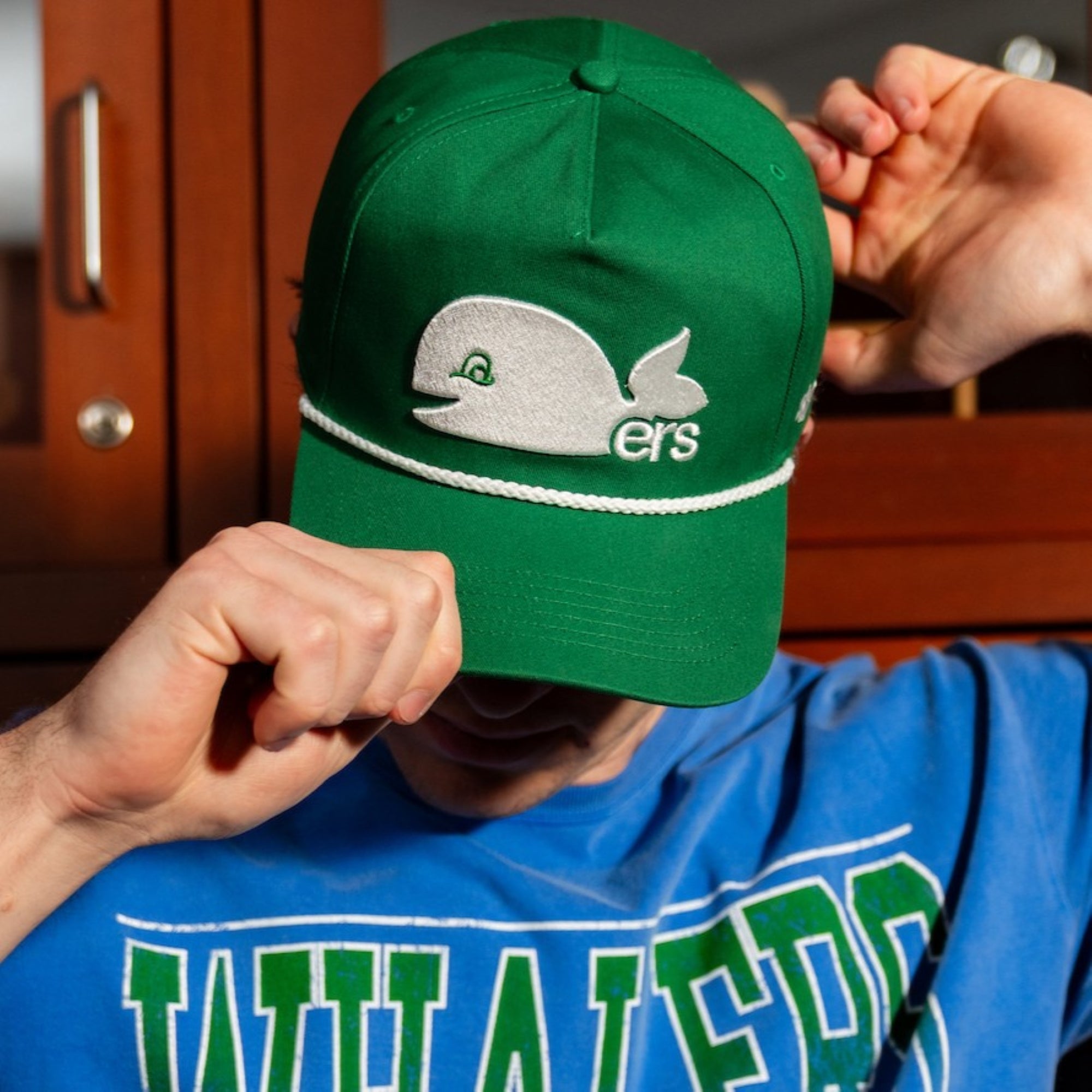 A model adjusting the hat on their head