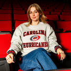 The crew being worn by a model while sitting in the Lenovo Center