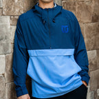 Front: Half-zip jacket, dark blue upper-half, light blue lower-half, blue Whalers Tail logo left chest
