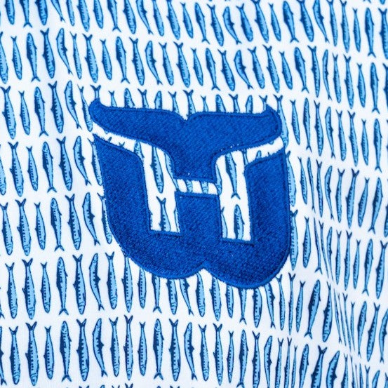 Close up of the Whalers Tail logo and the Sardine pattern