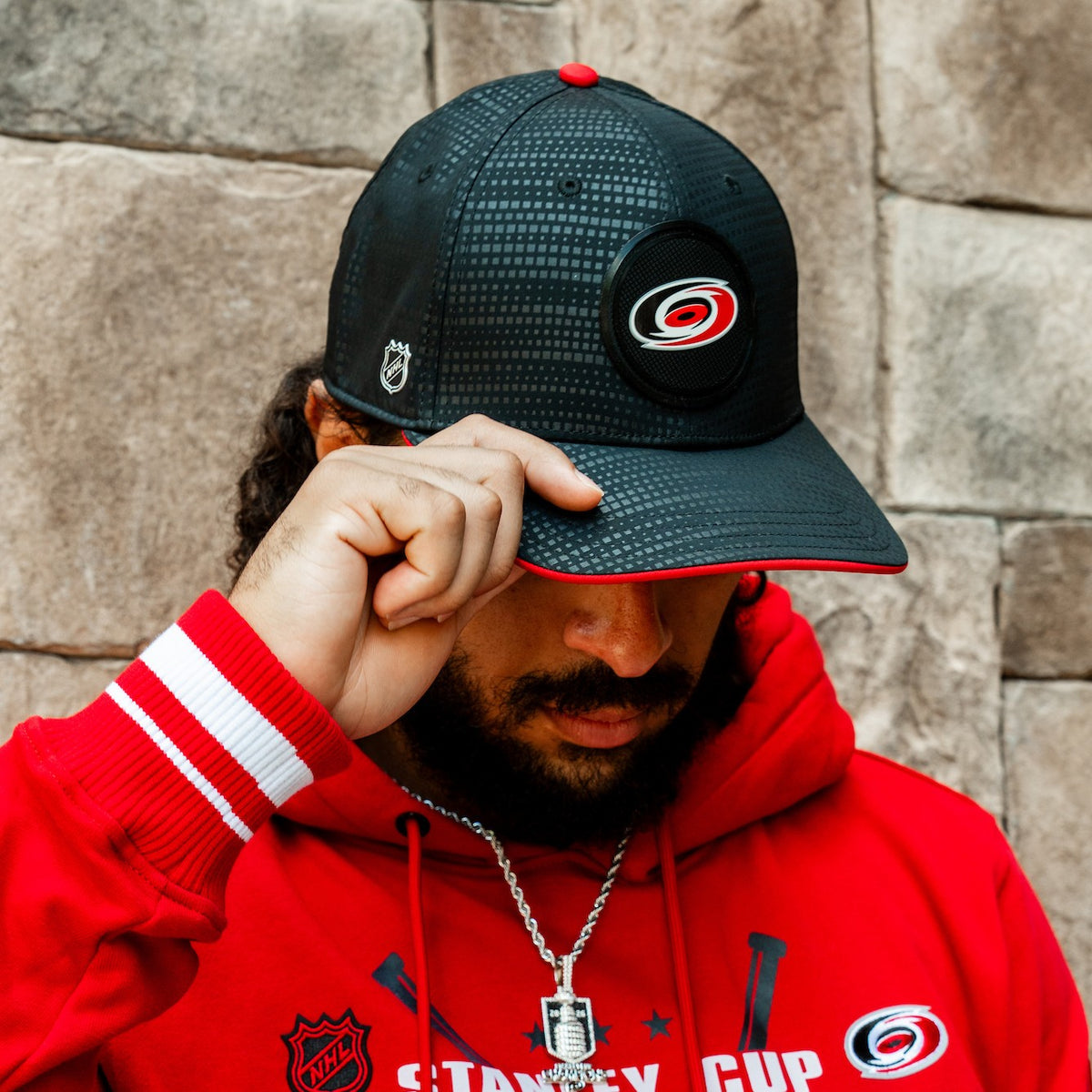 The hat being worn by Hurricanes defenseman Jalen Chatfield outdoors