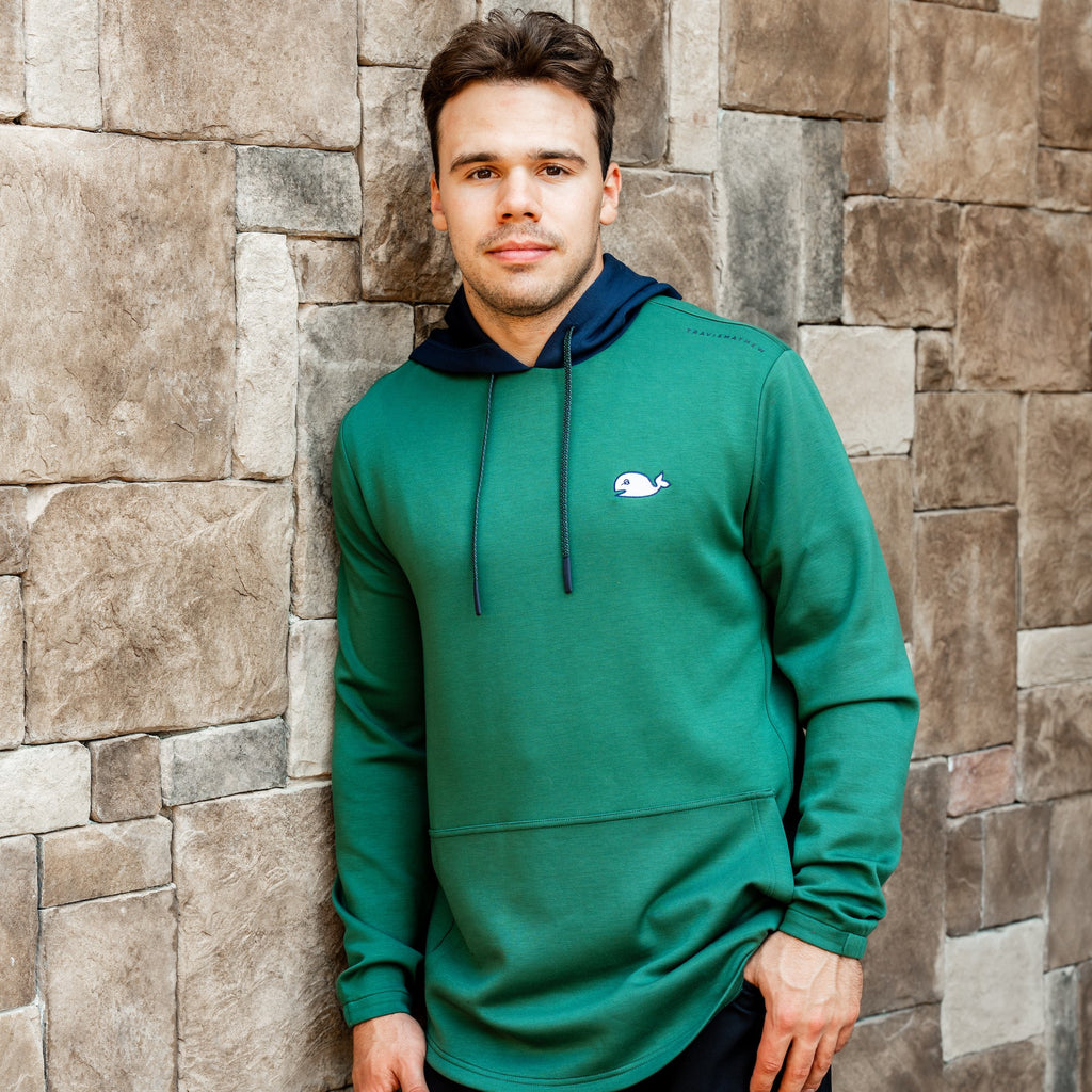 The hoodie being worn by Hurricanes forward Logan Stankoven next to a wall