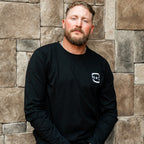 The shirt being worn by Hurricanes forward Nic Deslauriers in front of a wall