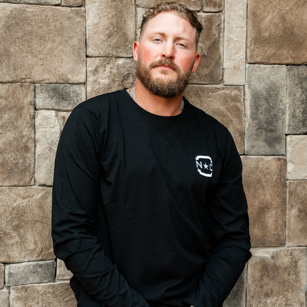 The shirt being worn by Hurricanes forward Nic Deslauriers in front of a wall