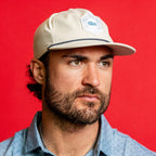 The hat being worn by Hurricanes forward William Carrier in front of a red background