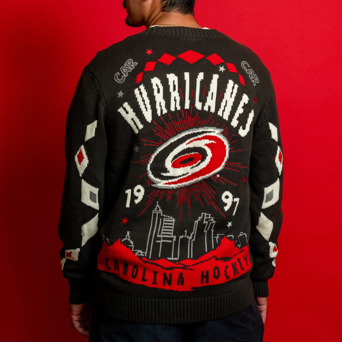 Back: "HURRICANES 1997" in white with Primary logo/Raleigh Skyline; "CAROLINA HOCKEY" in black at waist