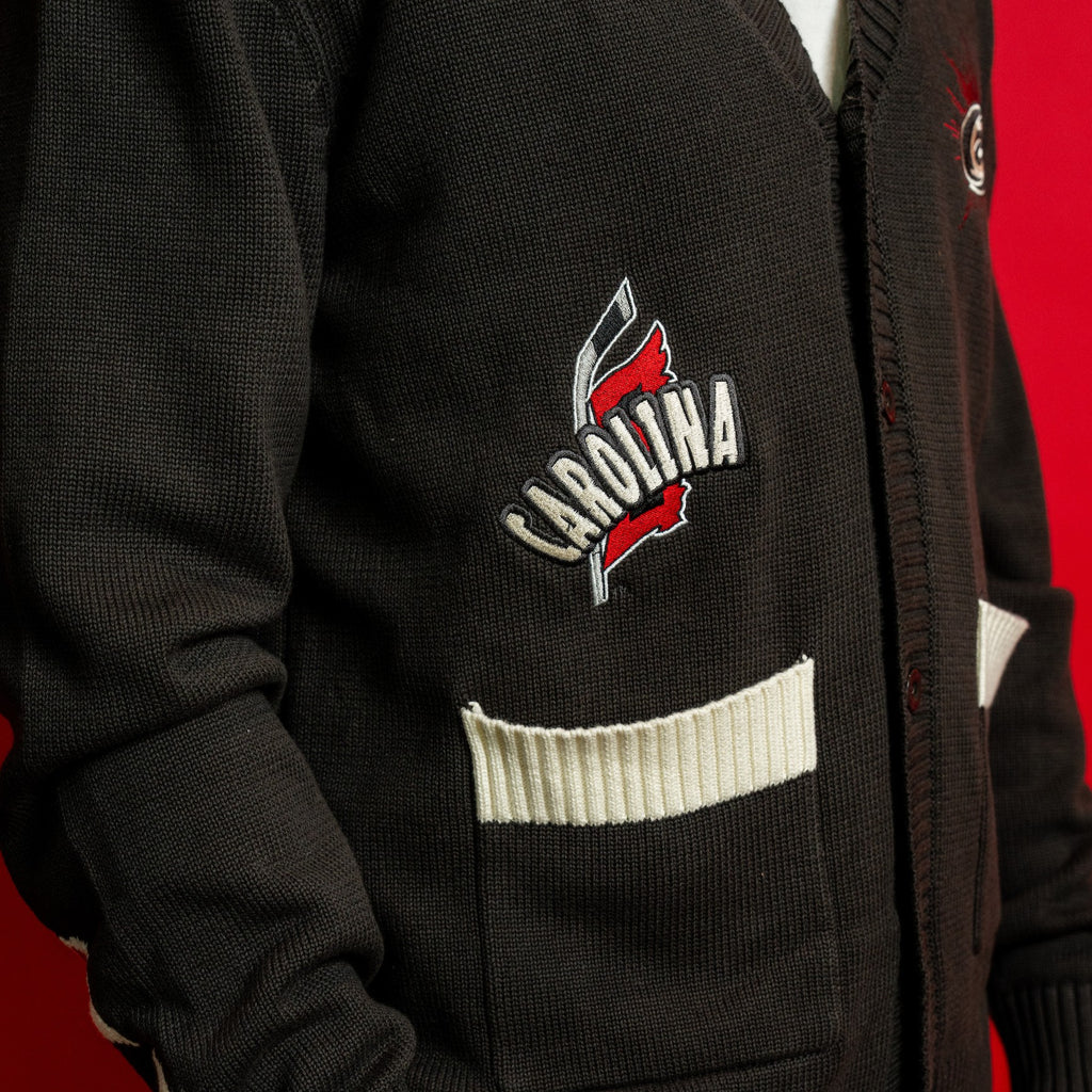 Close up of front right pocket and artwork; "CAROLINA" in white arched over Flags logo