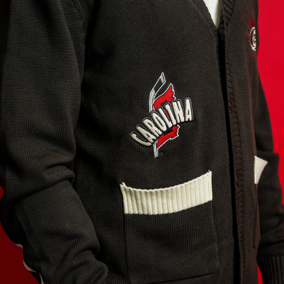 Close up of front right pocket and artwork; "CAROLINA" in white arched over Flags logo
