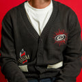 Front: Charcoal jacquard-style button sweater, front pockets, artwork on front