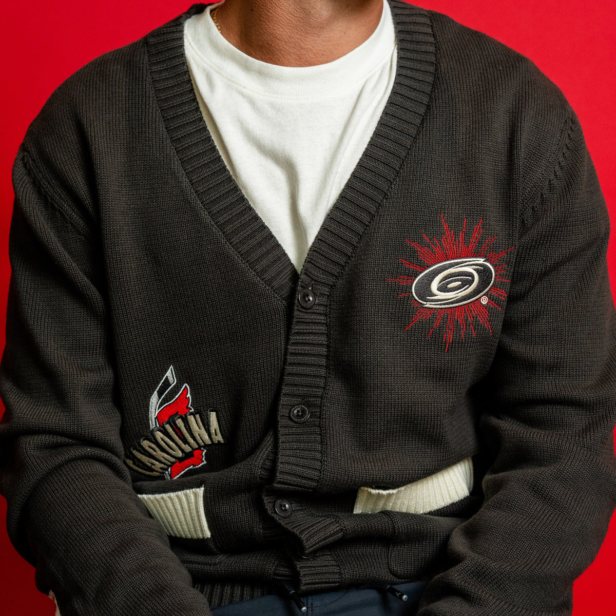 Front: Charcoal jacquard-style button sweater, front pockets, artwork on front