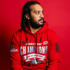 The hoodie being worn by Hurricanes defenseman Jalen Chatfield in front of red background