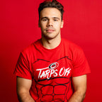 The tee being worn by Hurricanes forward Logan Stankoven in front of red background
