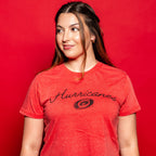 The tee worn by a model in front of a red background
