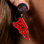 Silver earring with imprinted Primary logo, dangling red flag charm attached that says "GAME DAY"