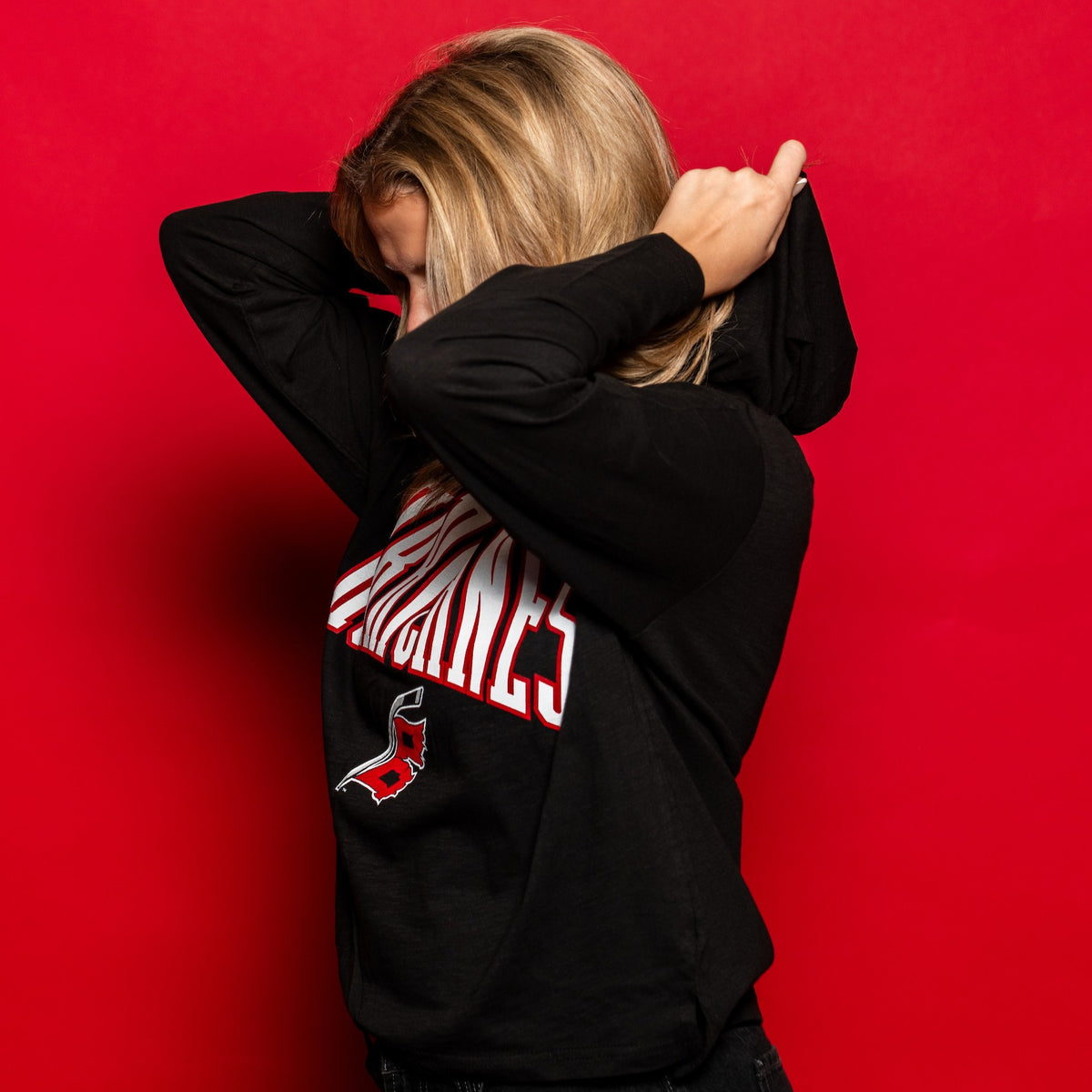 Side view showcasing the hood, worn by a model