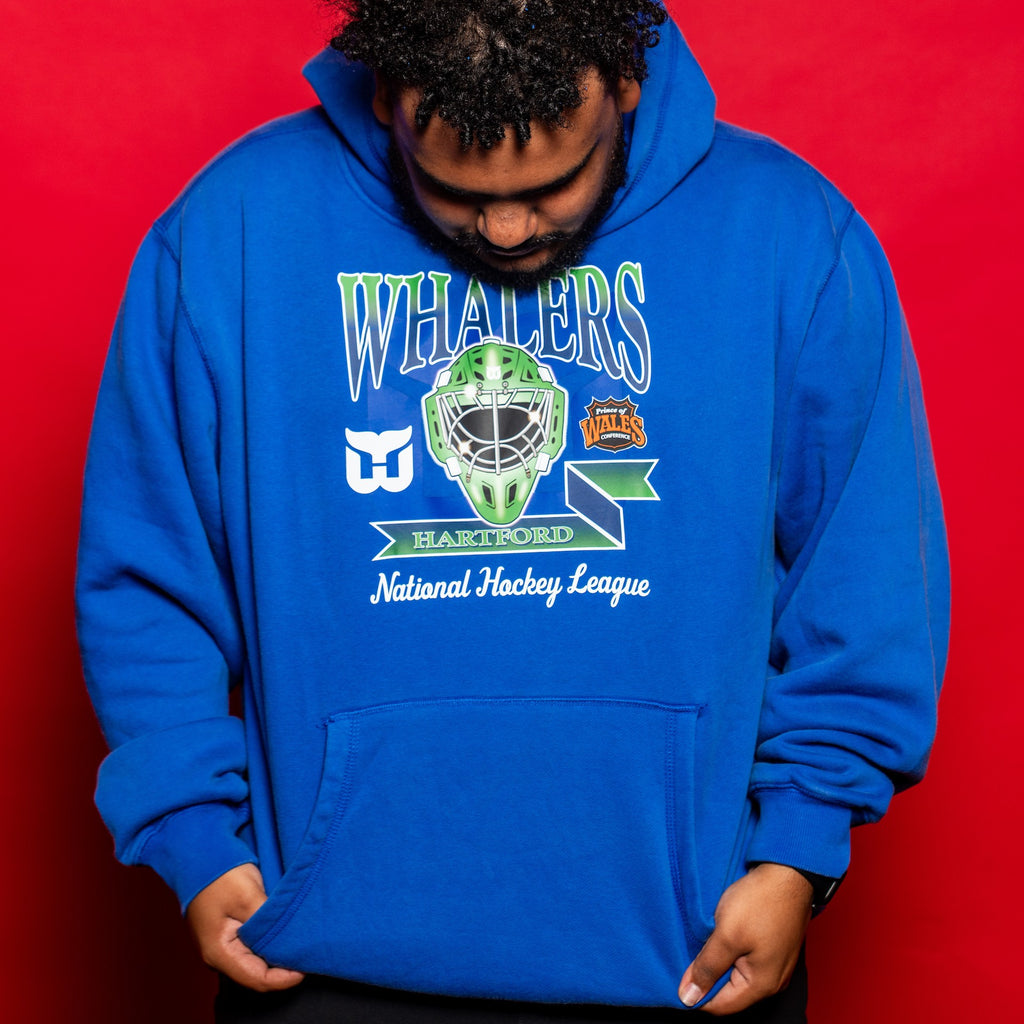 The hoodie being worn by a model in front of a red background
