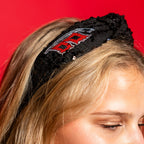 Black headband with Flags logo on side of headband