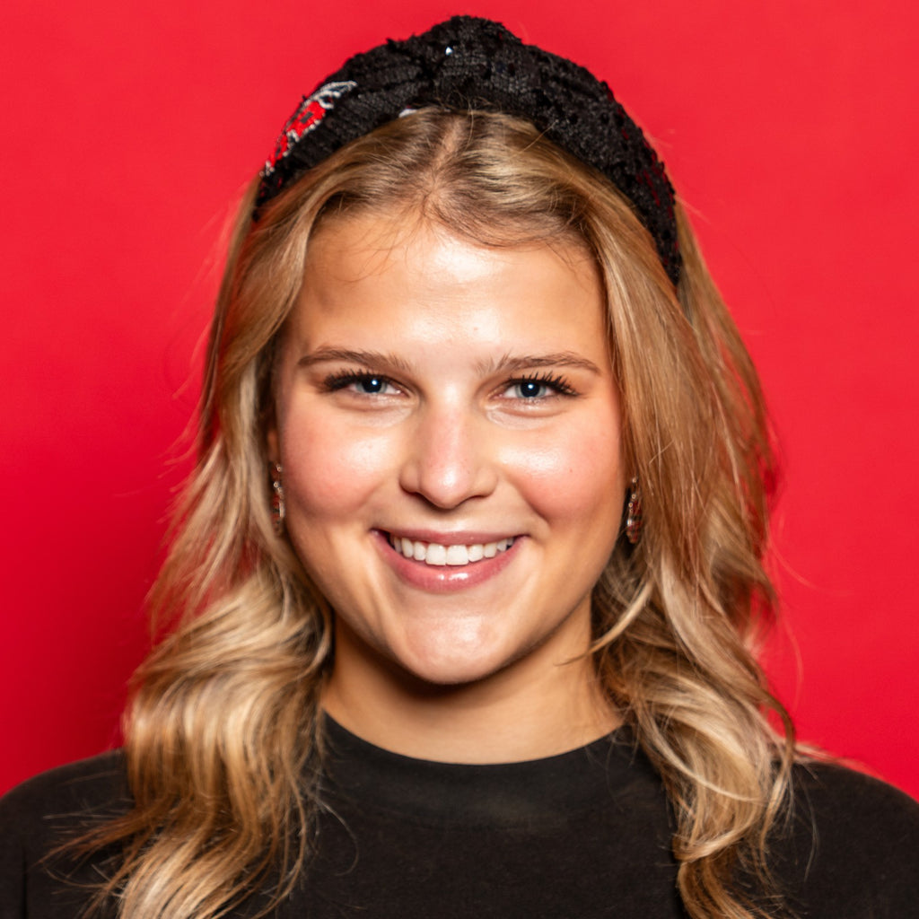 The headband being worn by a model in front of red background